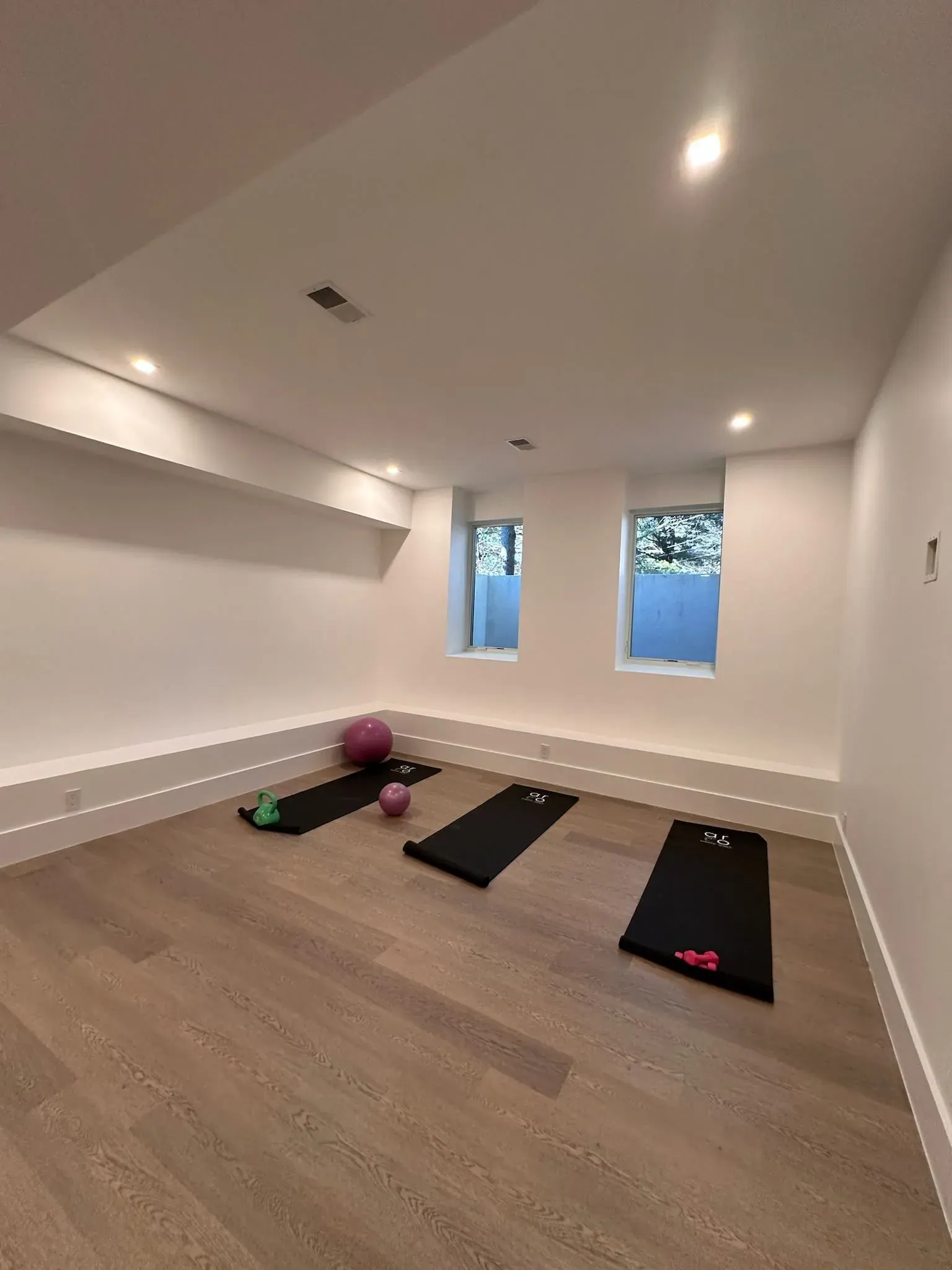 Exercise room with recessed lights and wood floors