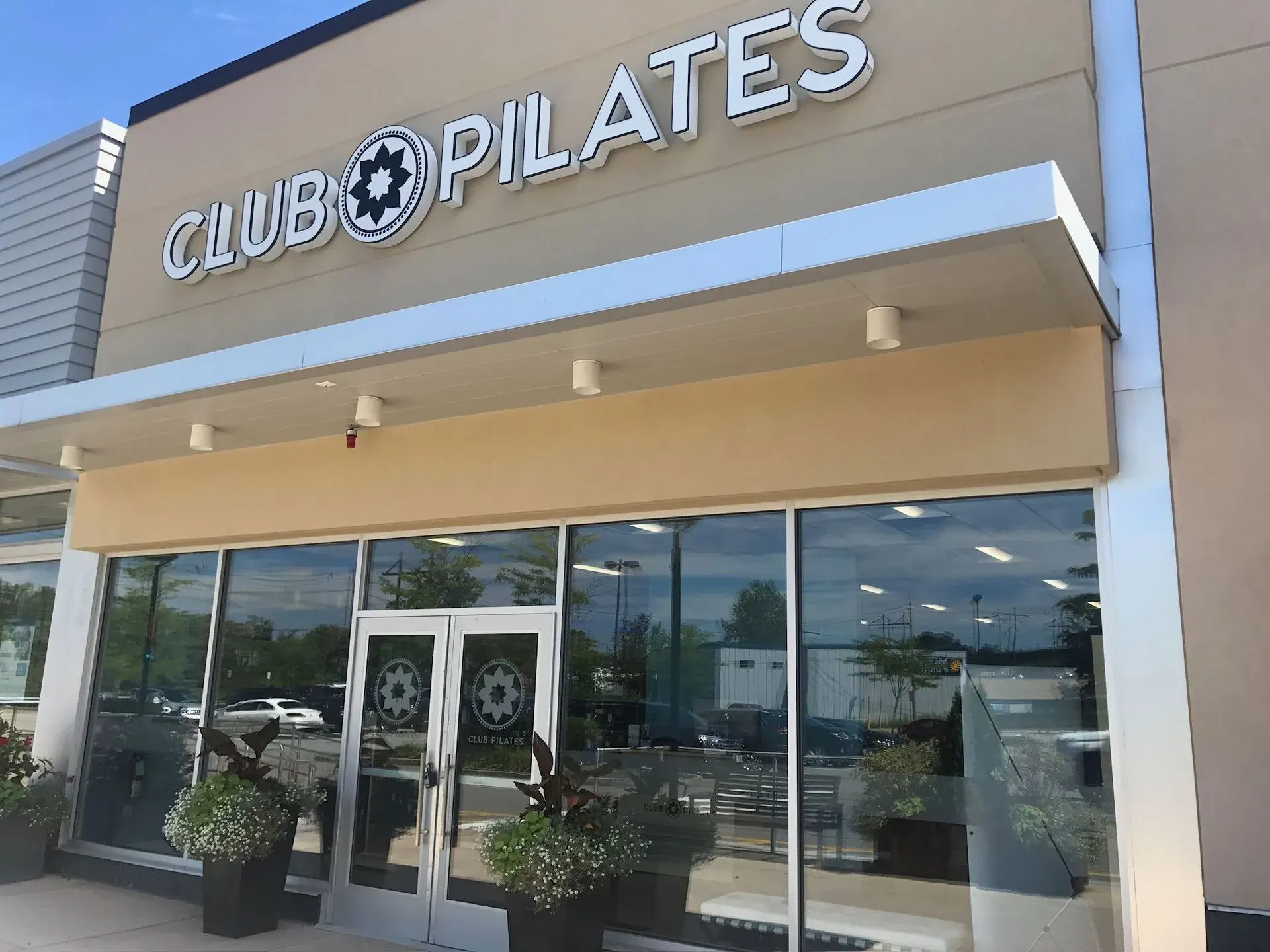 Fitness studio storefront with soffit downlights under the sign