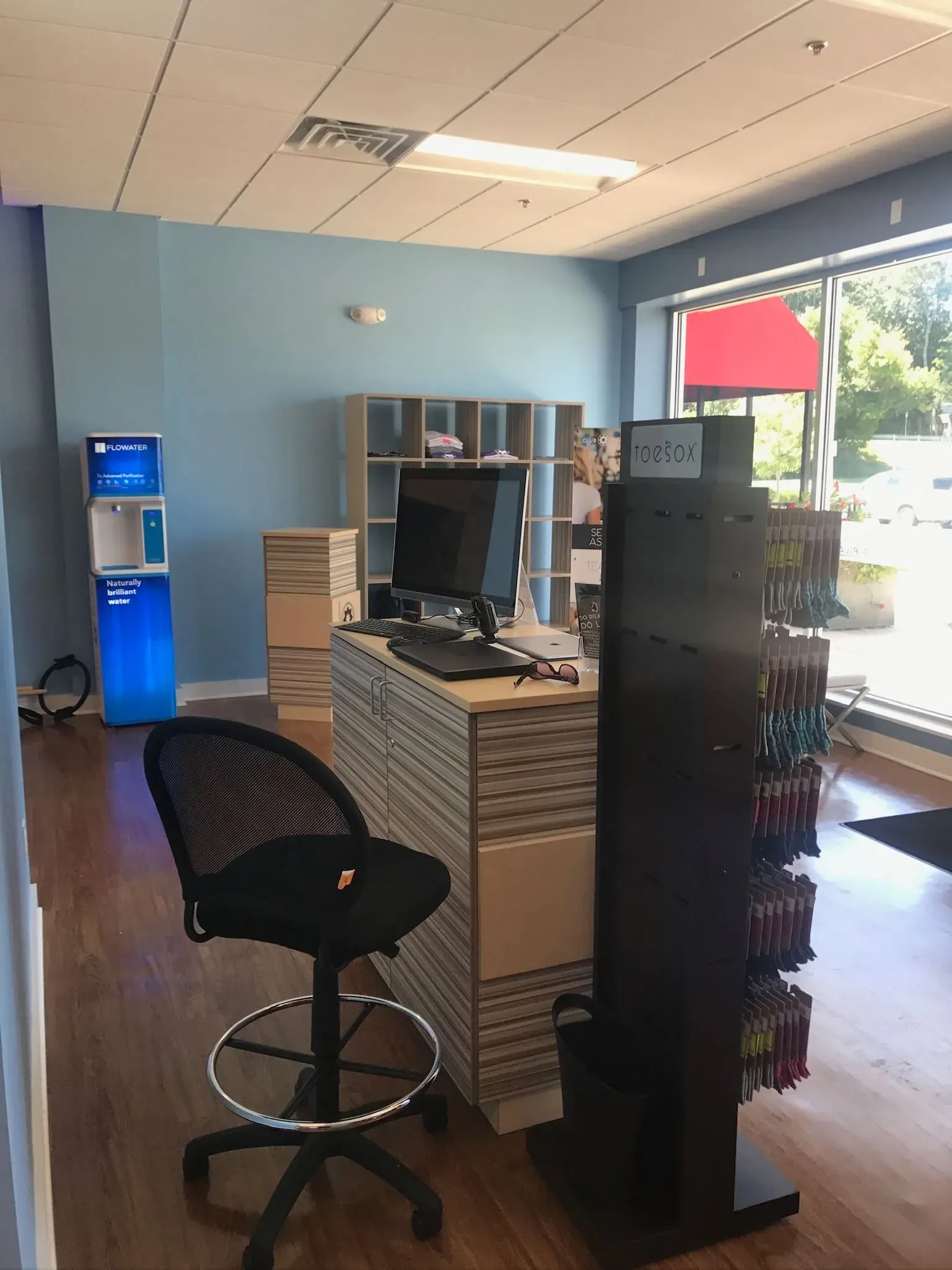 Fitness studio check-in desk by the storefront windows