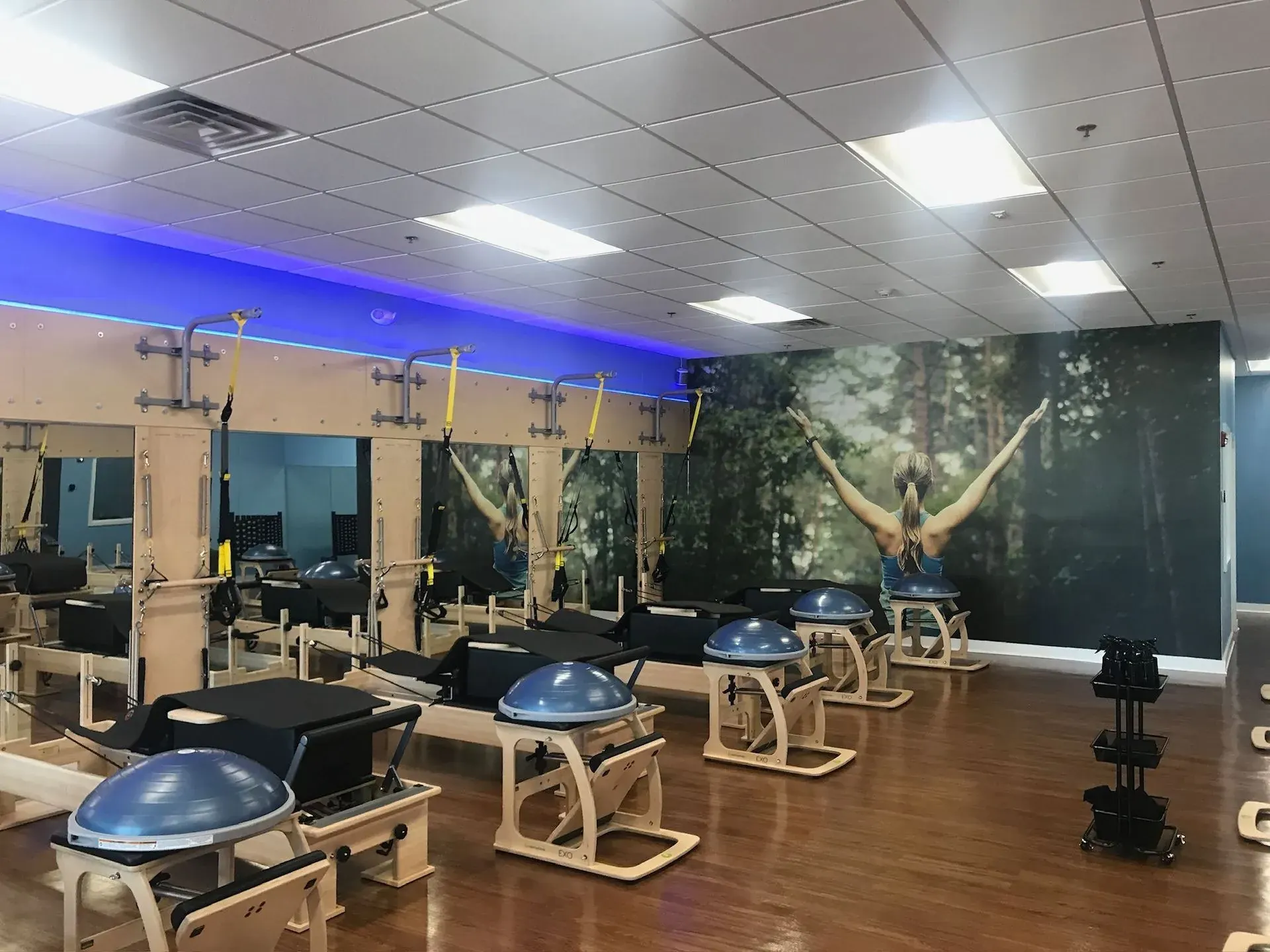 Fitness studio with LED flat panels and a blue accent cove