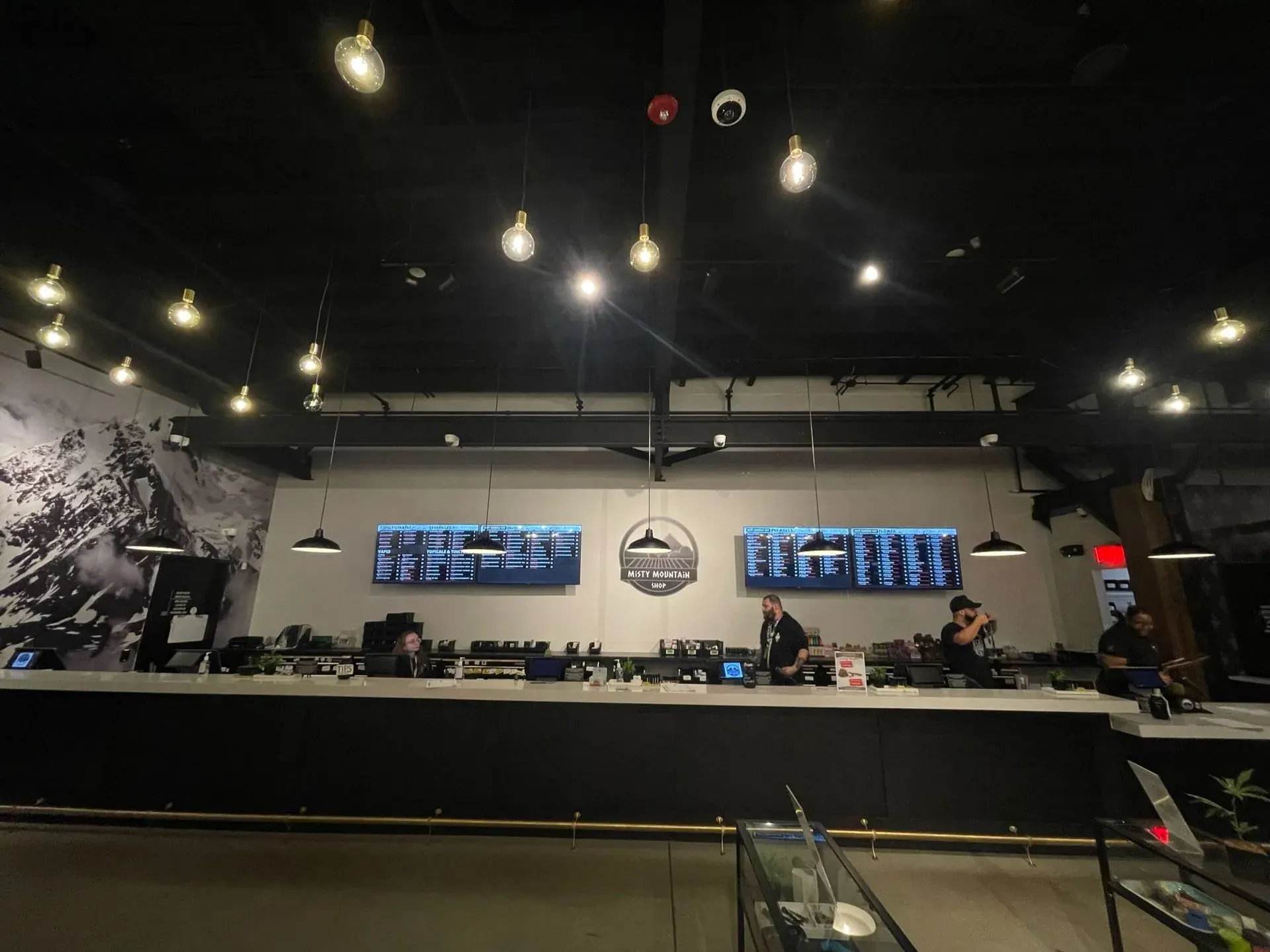 Retail sales floor lit by pendants and menu screens