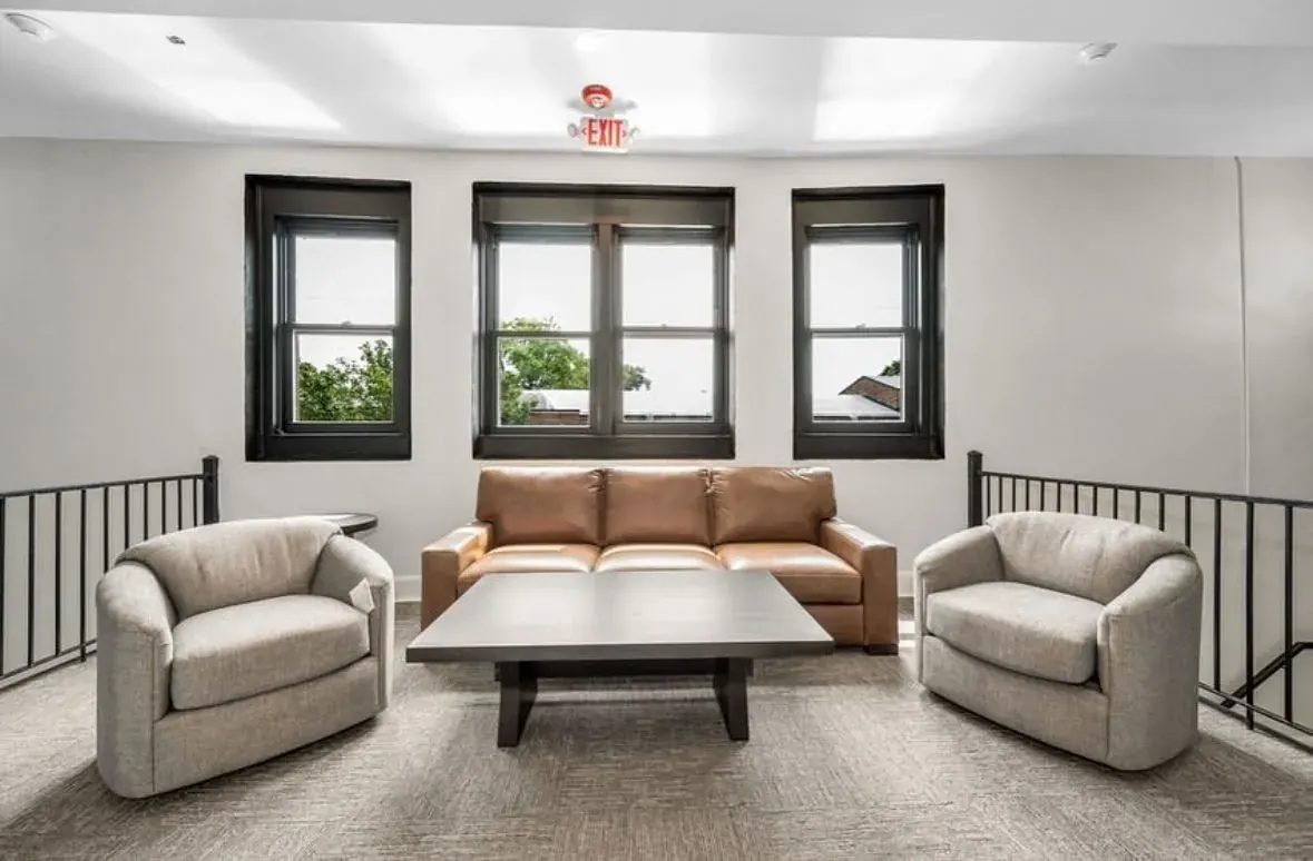 Upstairs lounge area with black-framed windows and even ceiling lighting
