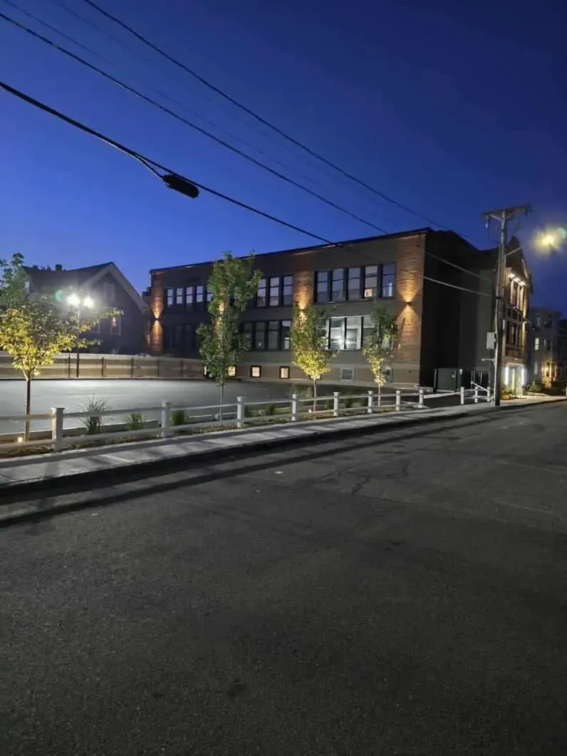 Brick building with exterior lighting at night from the street