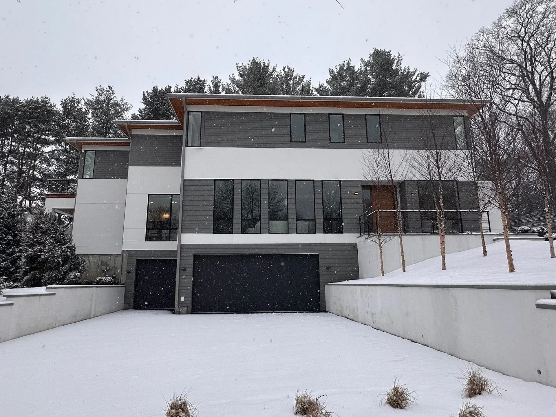 Contemporary new-construction home during a New England snowfall