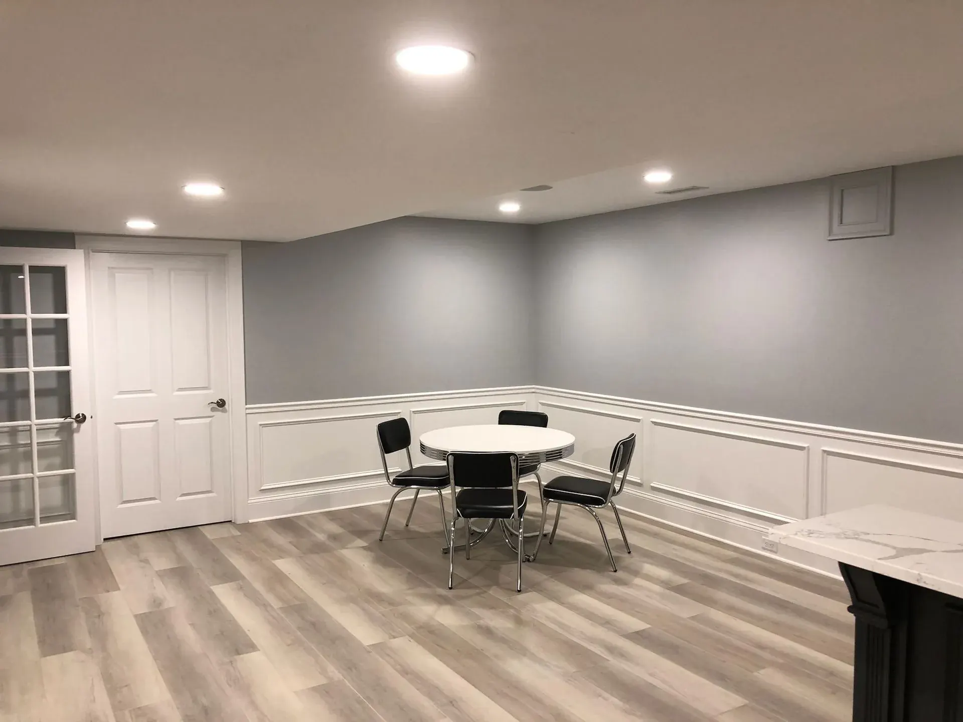 Finished basement dining area with recessed lighting