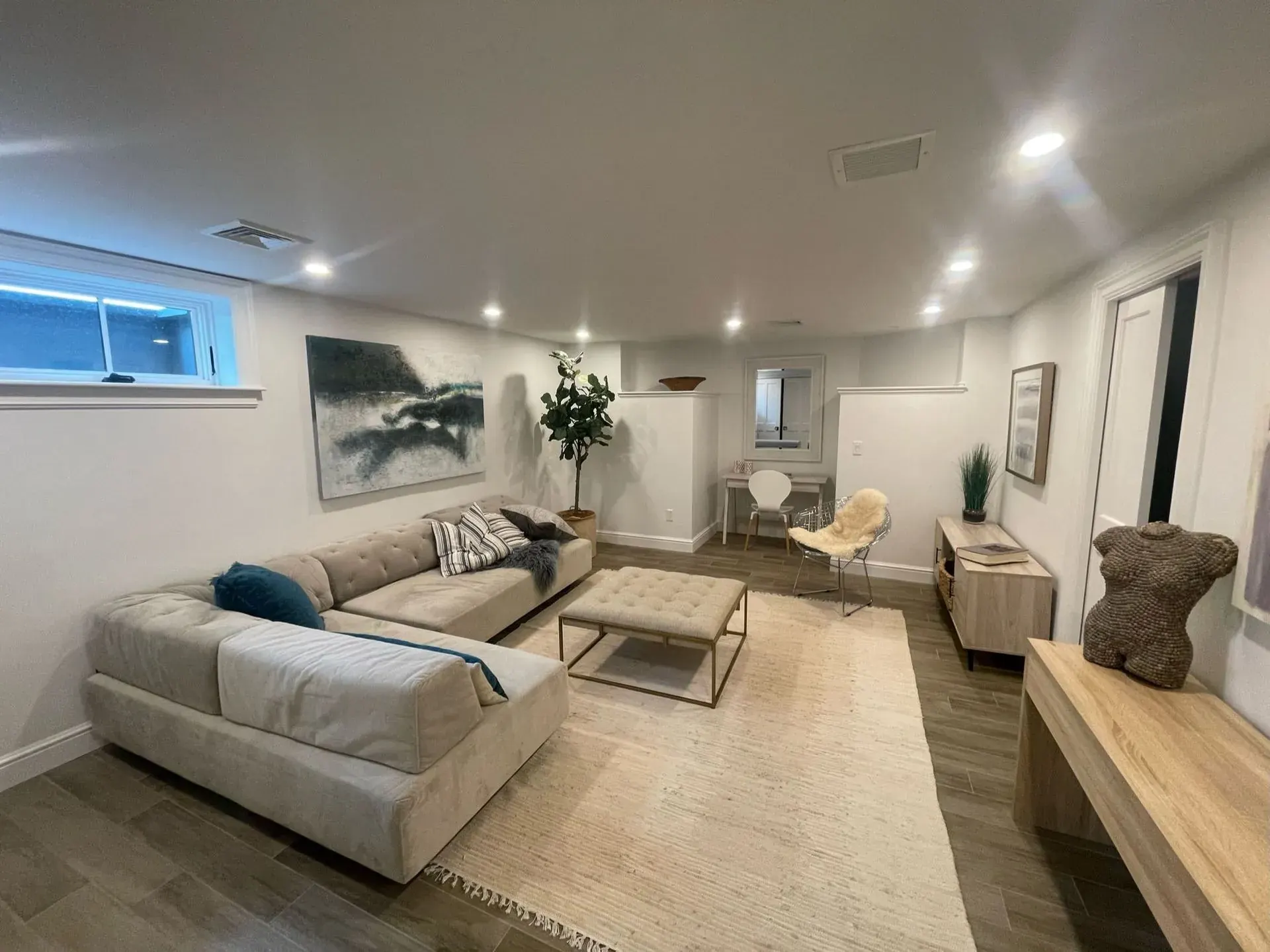 Finished basement living room with recessed lights