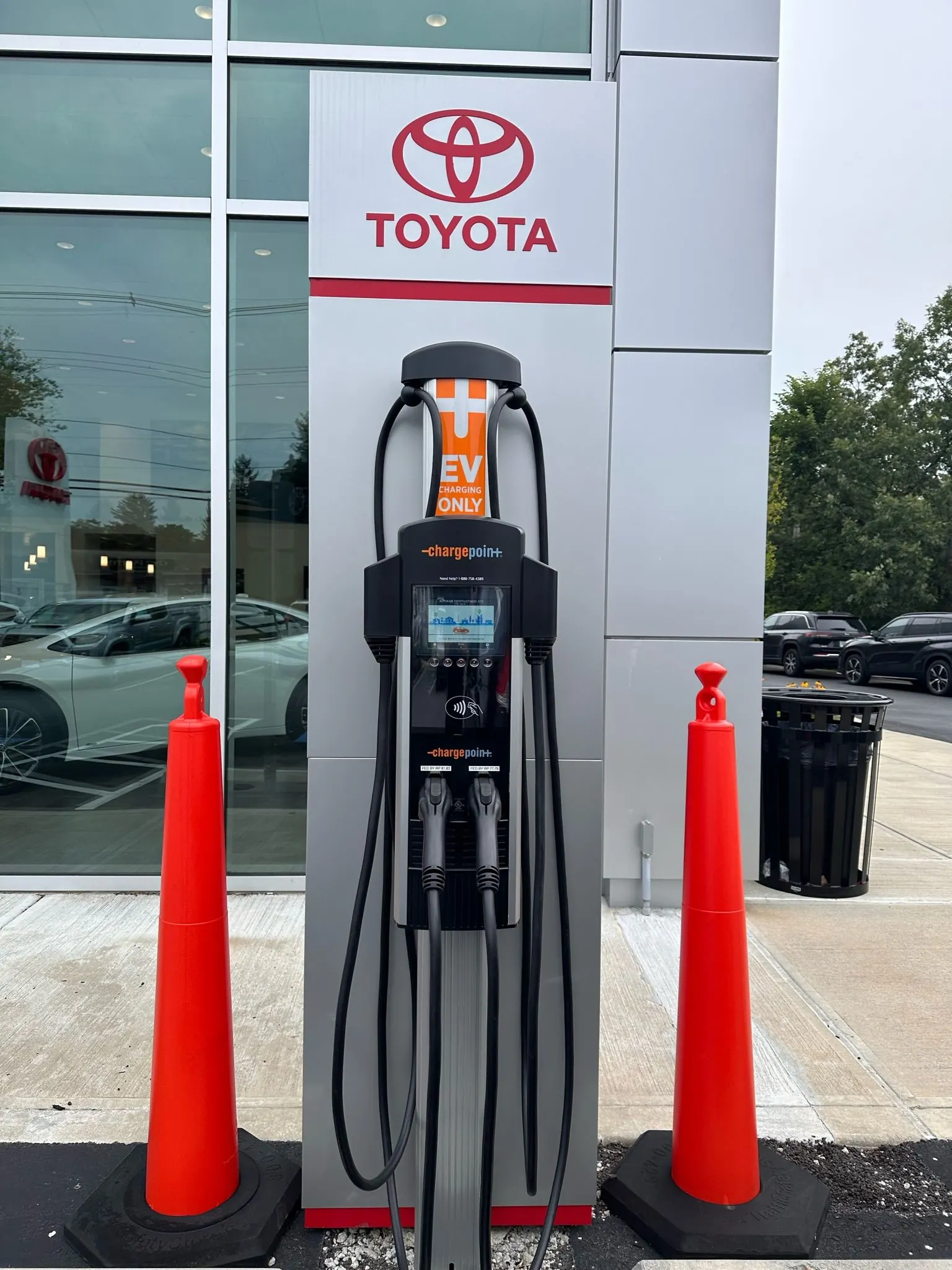 Level 2 EV charging pedestal installed outside a car dealership