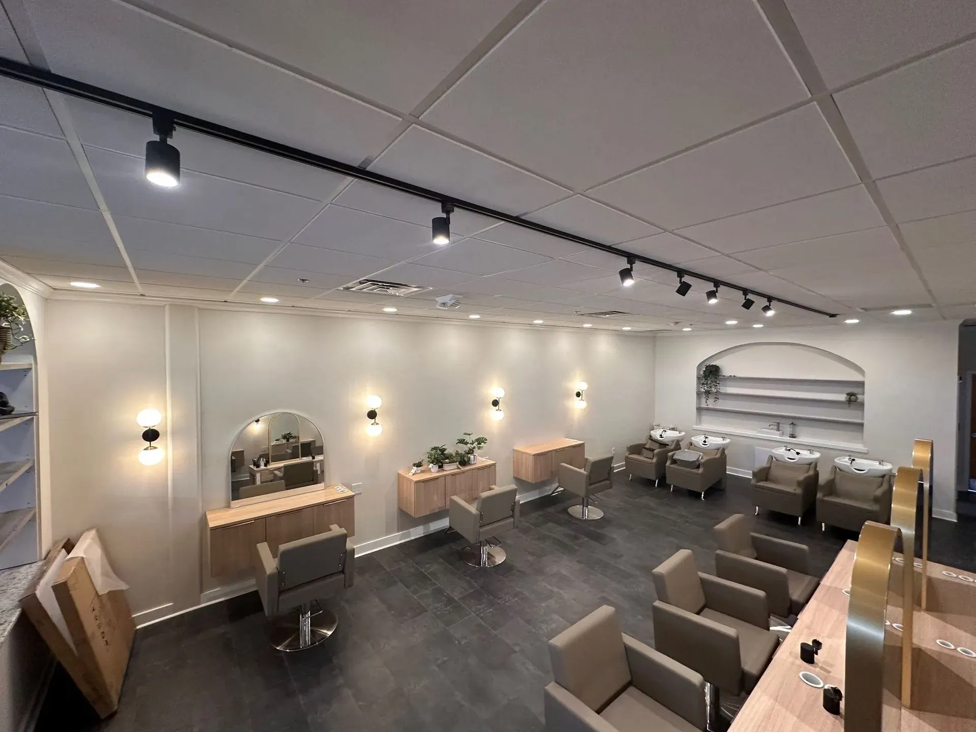 Salon styling floor lit by black track lighting
