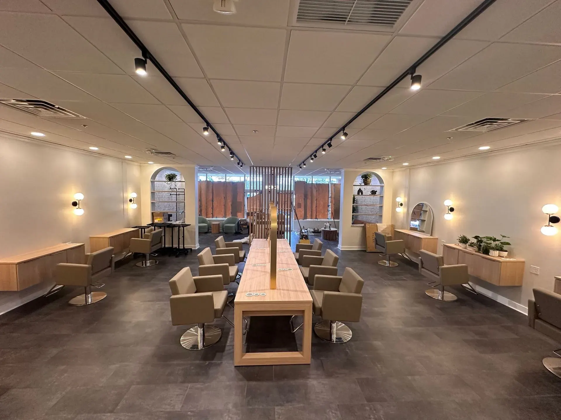 Hair salon floor lit by black track heads and wall sconces