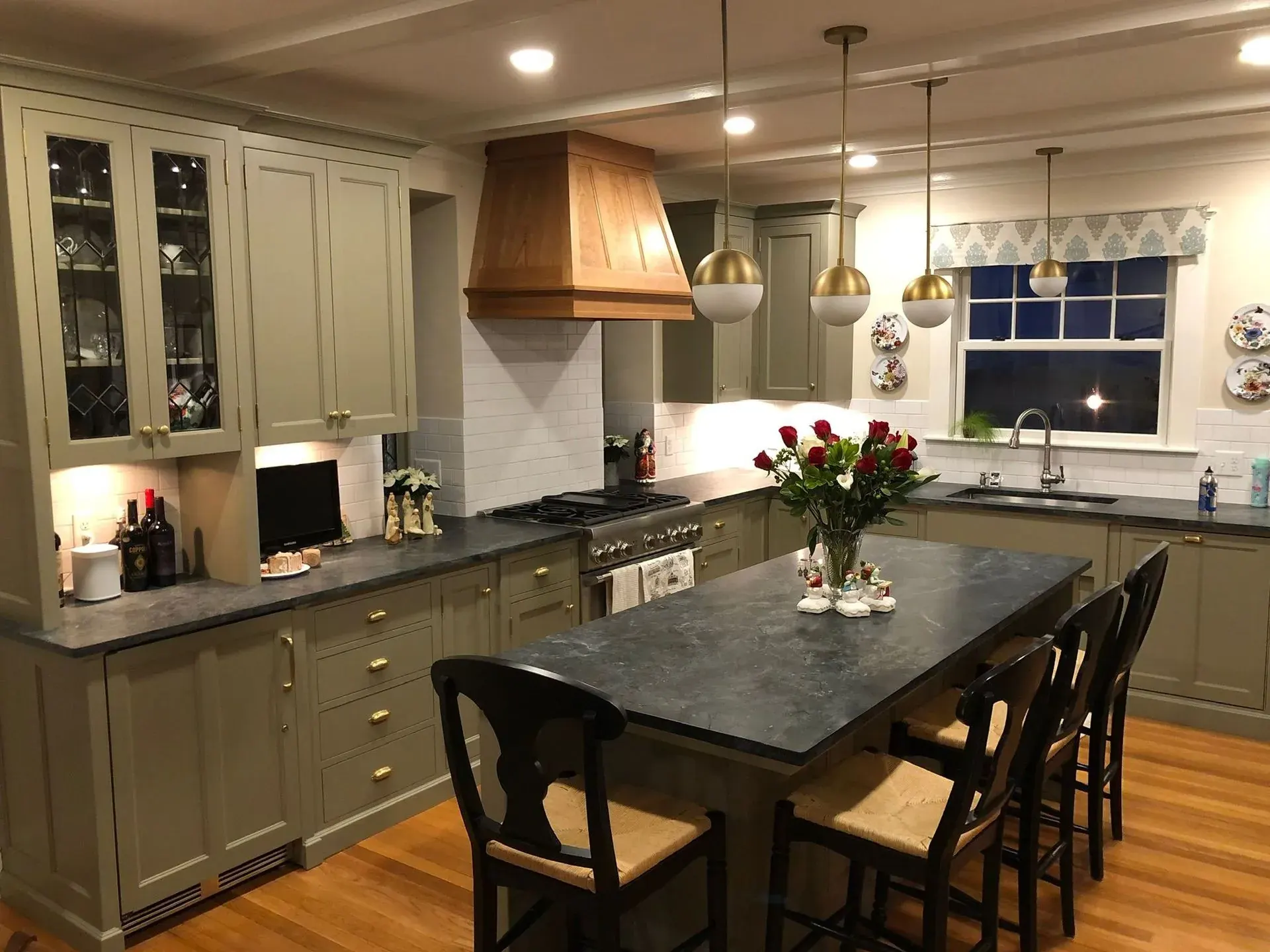 Kitchen with globe pendants over the island and under-cabinet lighting