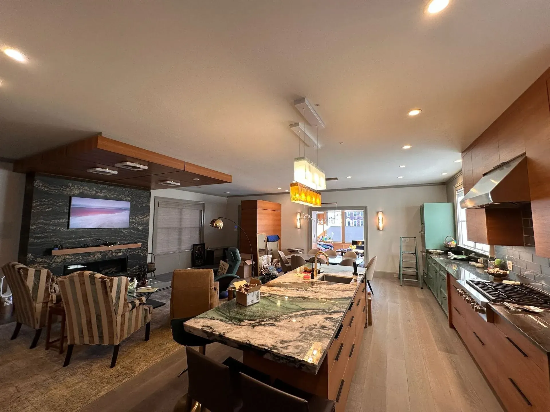 Open kitchen and family room with recessed and pendant lighting